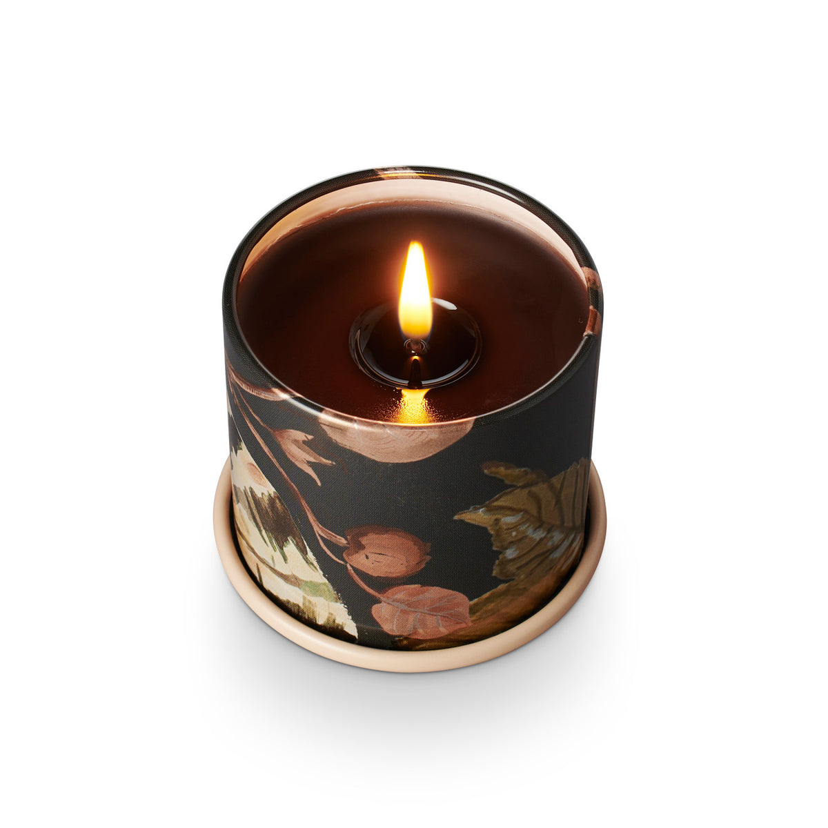 Candle in a decorative holder with floral design on a white background