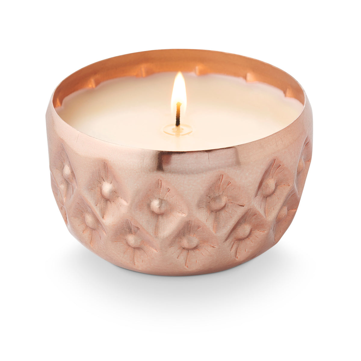 Illume Woodfire Radiant Pressed Metal Candle with warm metallic finish and textured geometric design.