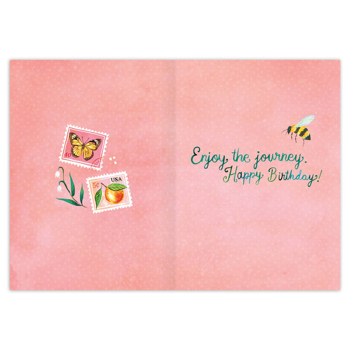 A pink folded greeting card shown open, with decorative postage-style stamps, a butterfly, a small plant, and the text 'Enjoy the journey. Happy Birthday!' in teal script.