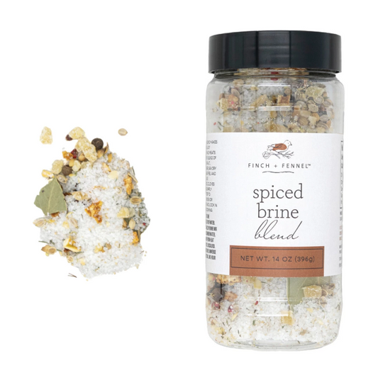 Jar of Spiced Brine Blend with coarse sea salt, ginger, orange peel, and warming spices, perfect for roasting poultry and meats.
