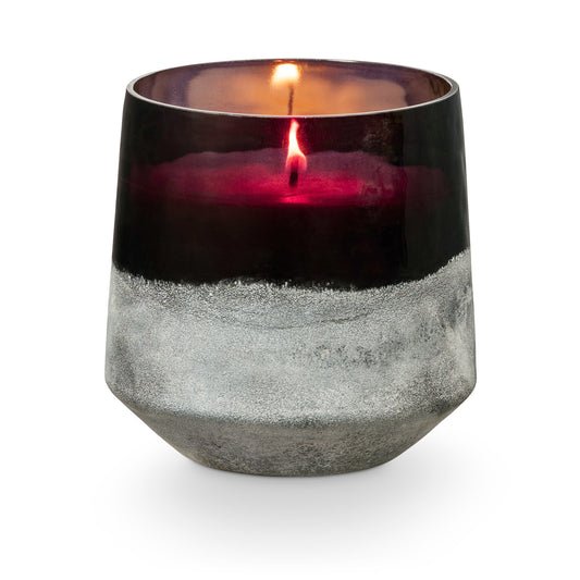 Lit Midnight Pumpkin candle in dark Baltic glass vessel
