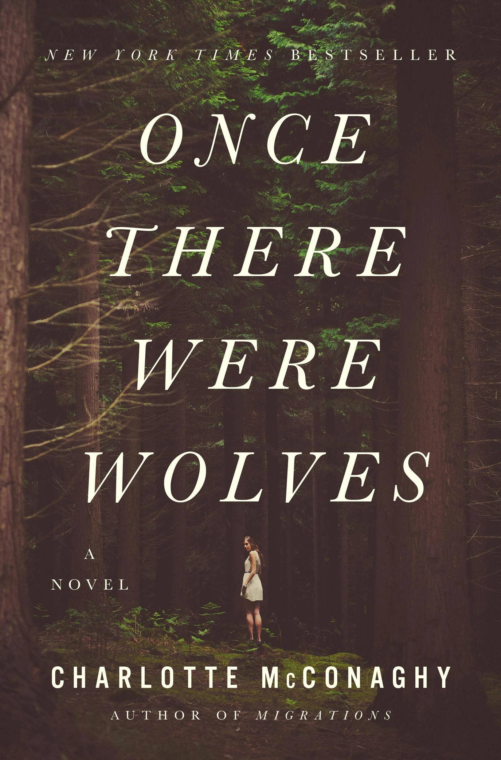 Book cover of 'Once There Were Wolves' by Charlotte McConaghy with a forest background.