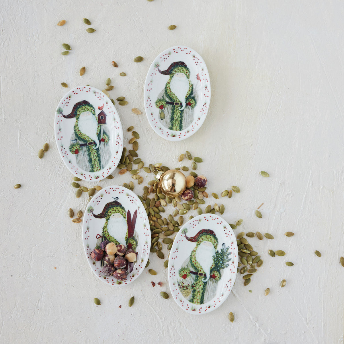 Four stoneware Santa Christmas plates with illustrated Father Christmas scenes and red berry and greenery borders.
