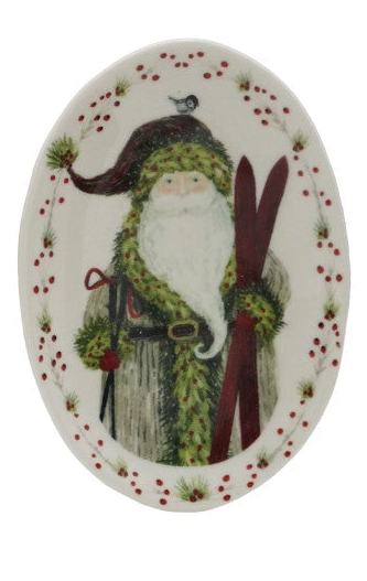 Stoneware Christmas plate featuring Santa with skis and a red berry and greenery border.