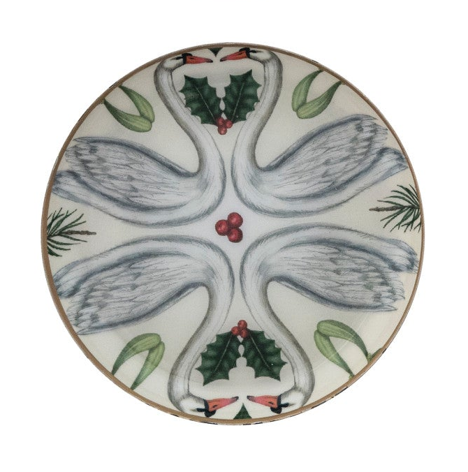 Round enameled metal trinket dish with swan and botanical illustration and gold-toned edge.