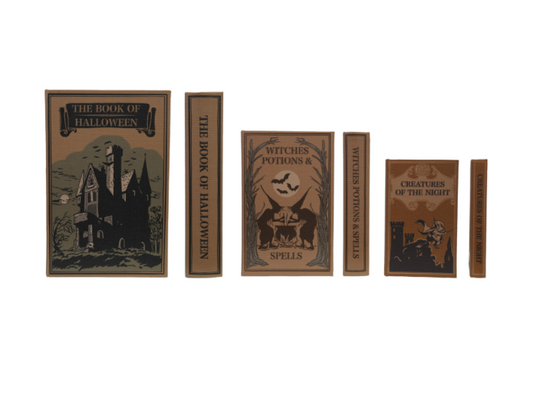 Vintage Halloween-themed decorative books, including 'The Book of Halloween', 'Witches Potions & Spells', and 'Creatures of the Night'.