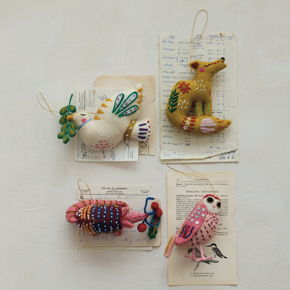 Wool felt armadillo, fox, owl, and dove ornaments with embroidered and beaded details.